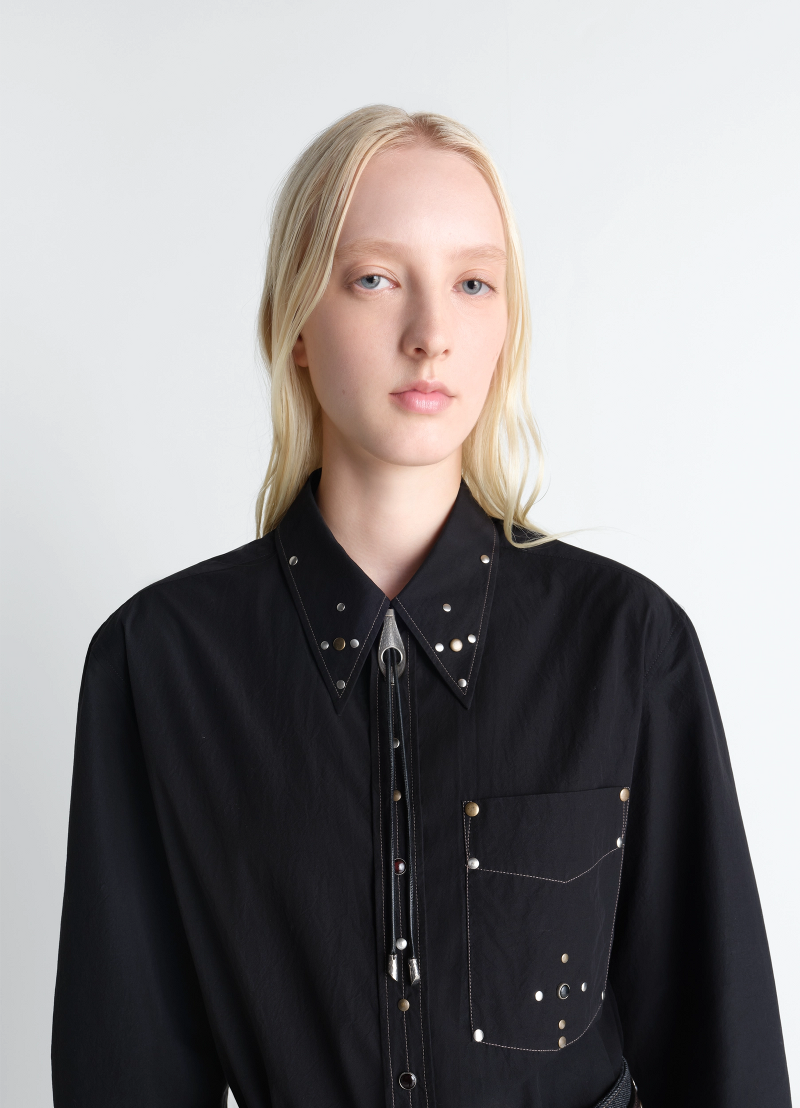 Snake bolo tie necklace in leather and brass, model shot, detail shot view worn over collared shirt