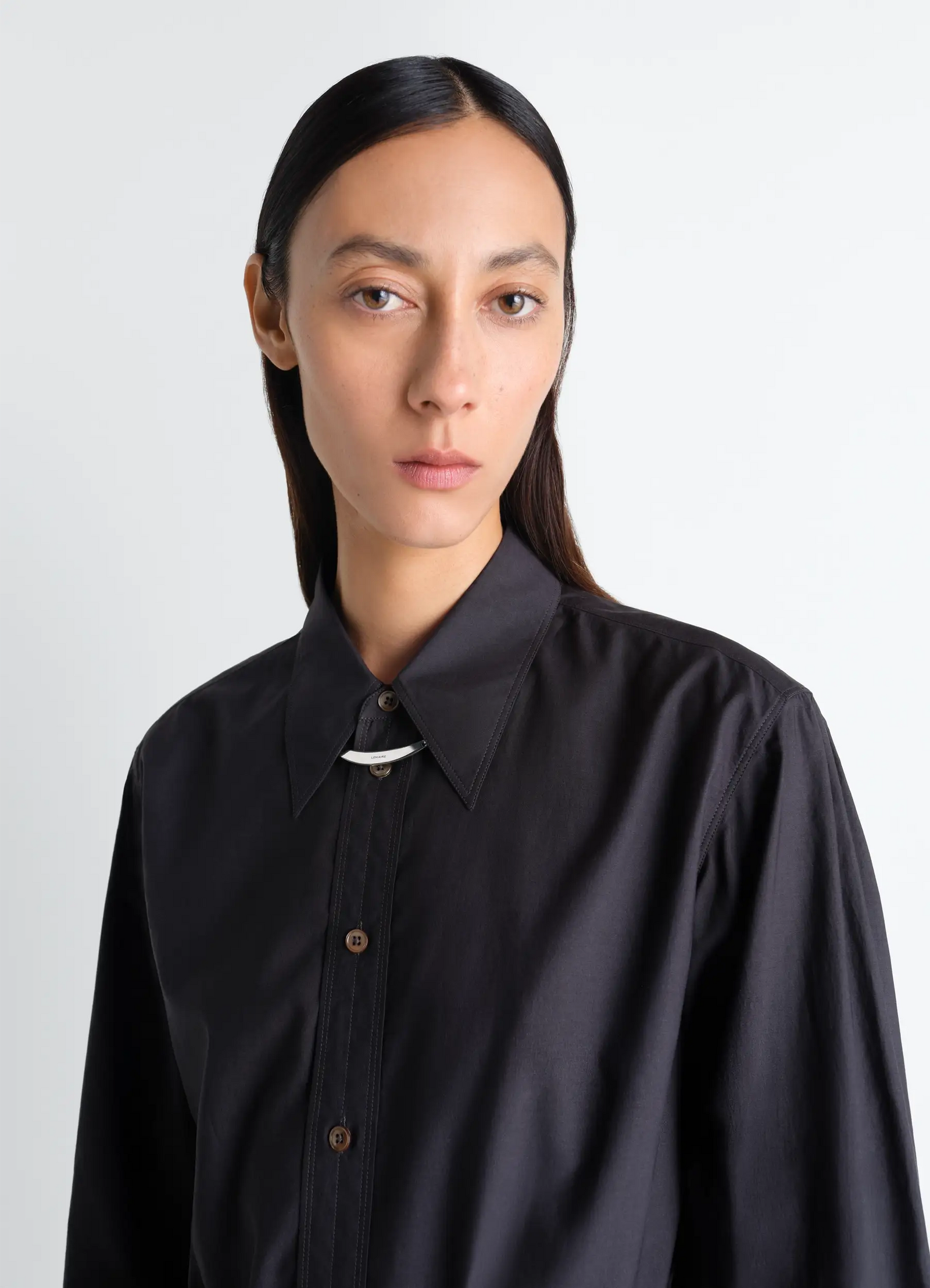 Id necklace in silver in silver sterling, model shot, close-up view worn over shirt