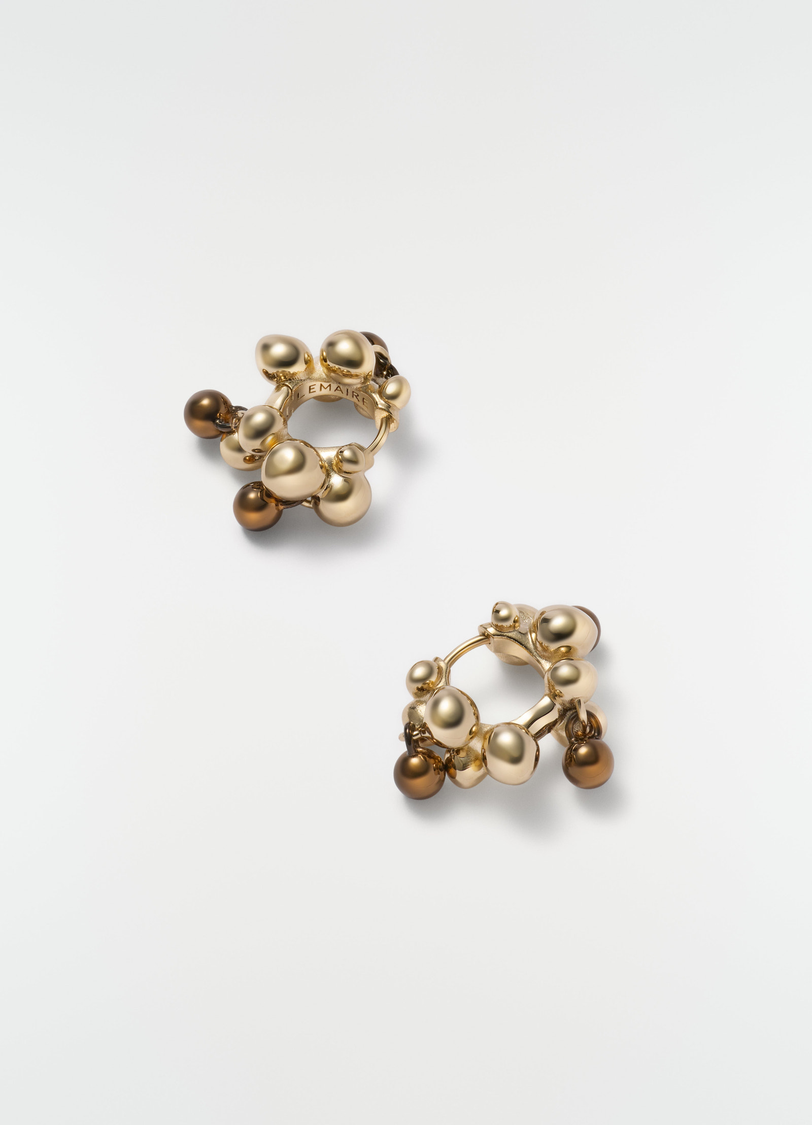 Seeds gold-tone brass hoop earrings with brown beads by lemaire flat lay on white background
