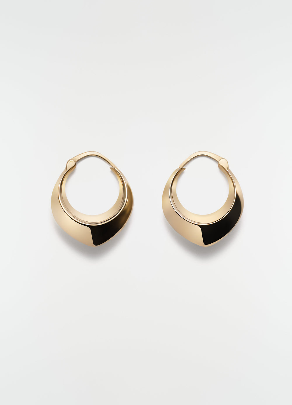 Drop edge hoop earrings in gold-plated silver by LEMAIRE on plain white background front view