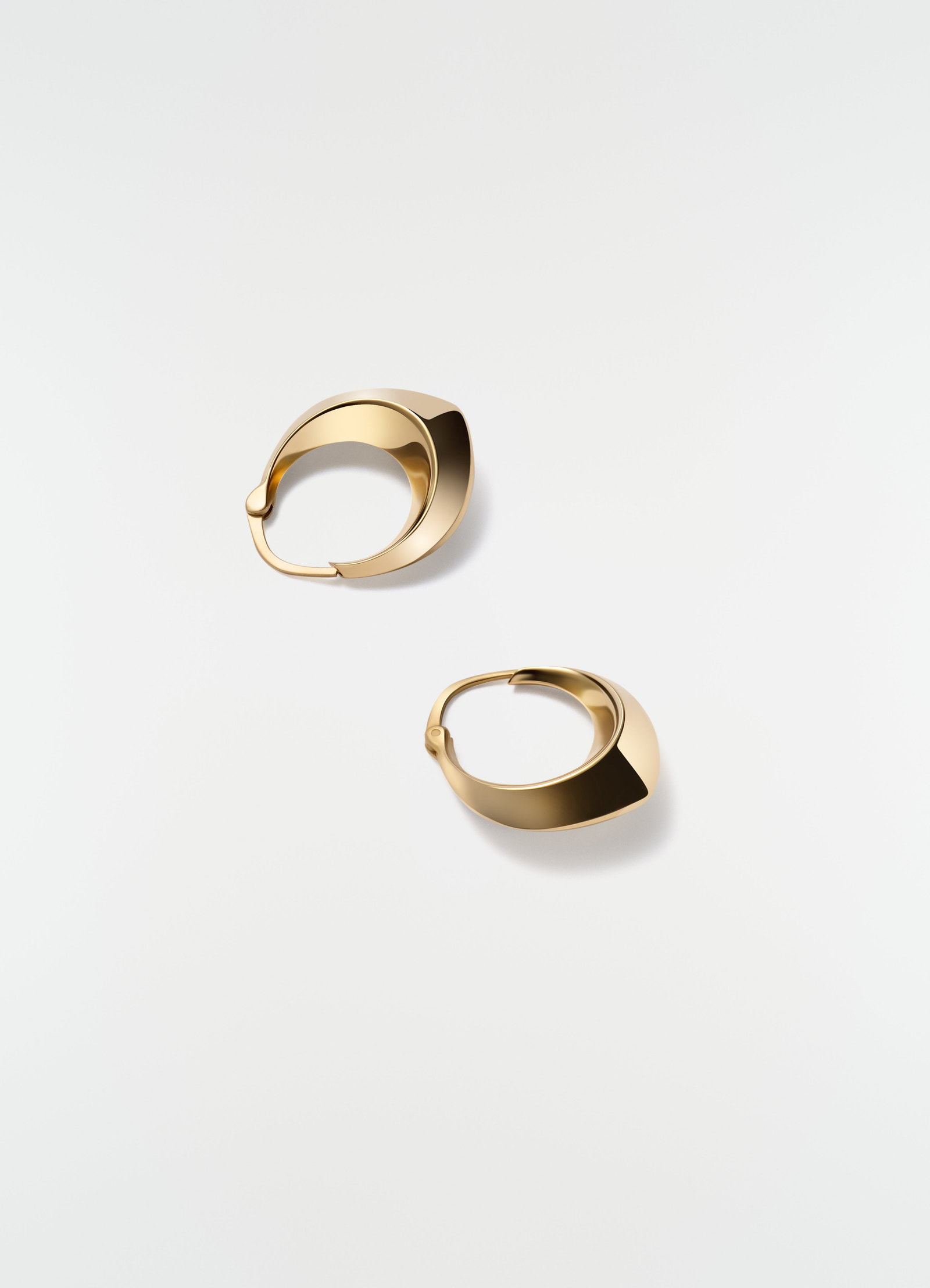 Drop edge hoop earrings gold-plated silver by lemaire styled on plain white background close-up detail