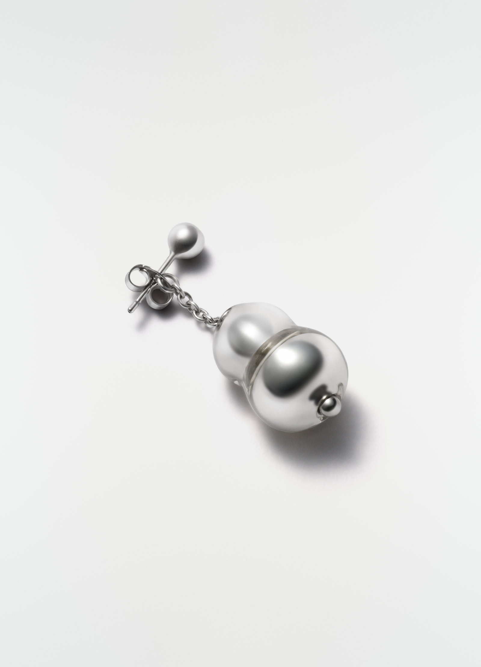 Blown glass silver-tone single earring with chain detail by lemaire on plain white background