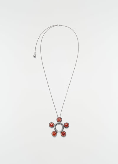 Garment ornament and necklace in silver brass with red stones by LEMAIRE on plain white background