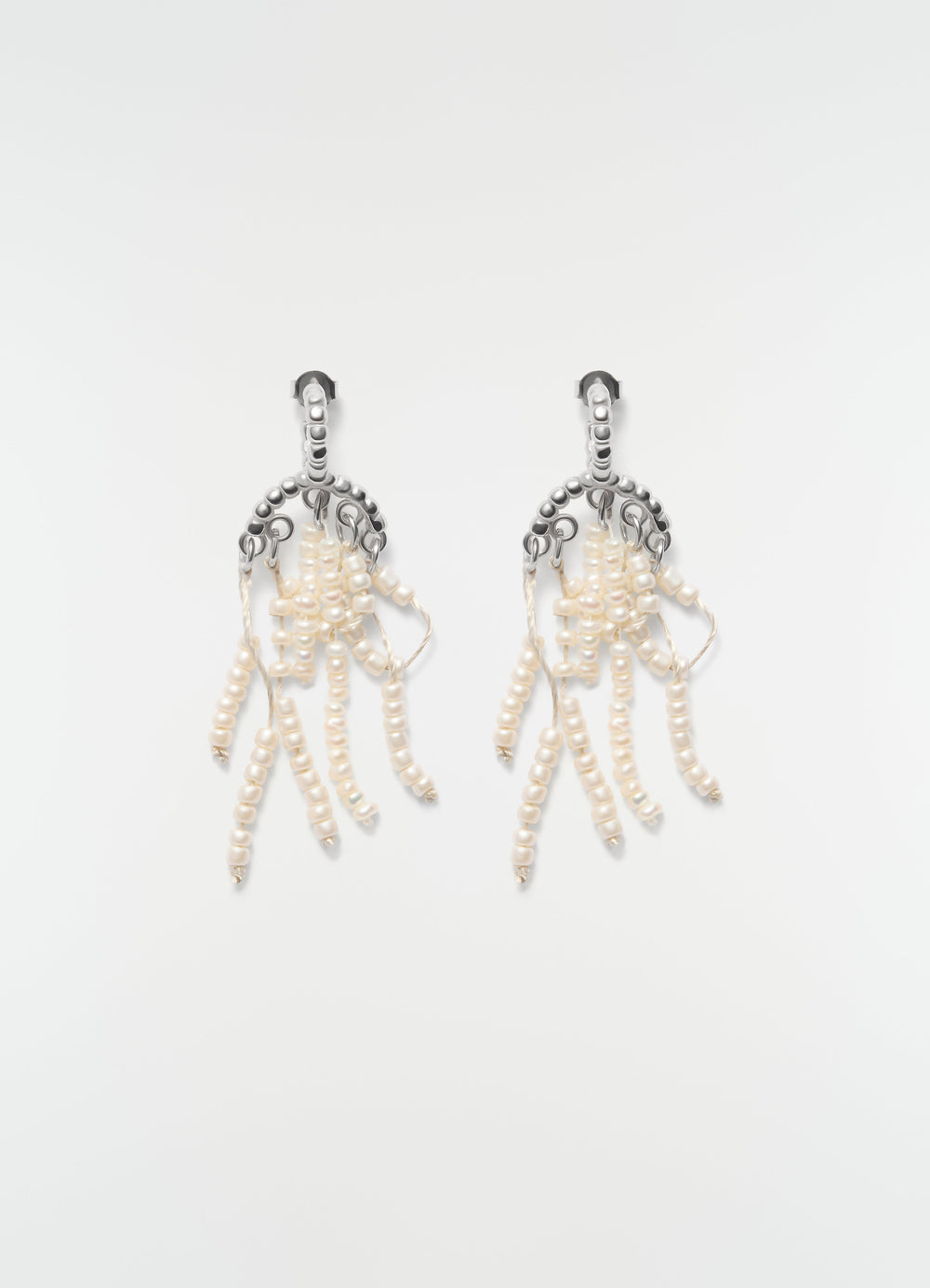 Short silver and white glass bead tassel earrings LEMAIRE front on plain white background