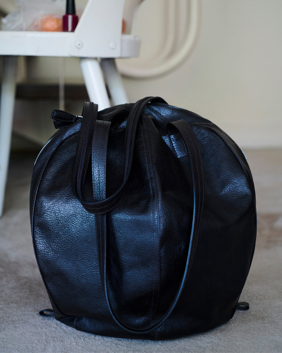 Hobo helmet bag in black grained leather by LEMAIRE front view on plain white background