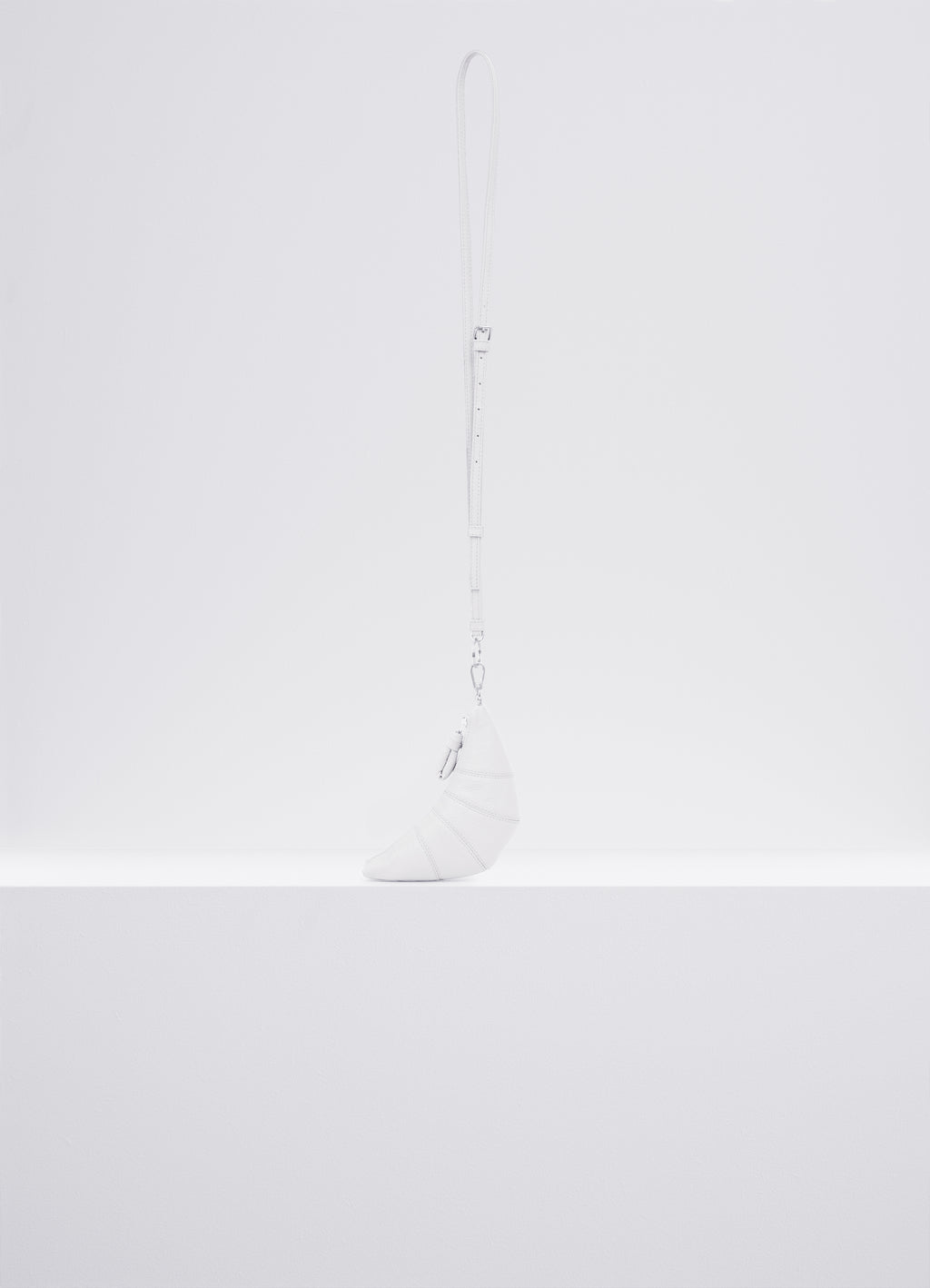 CROSS-BODY CROISSANT COIN PURSE in Soft grained leather, product shot, Side view Topstitched cutouts