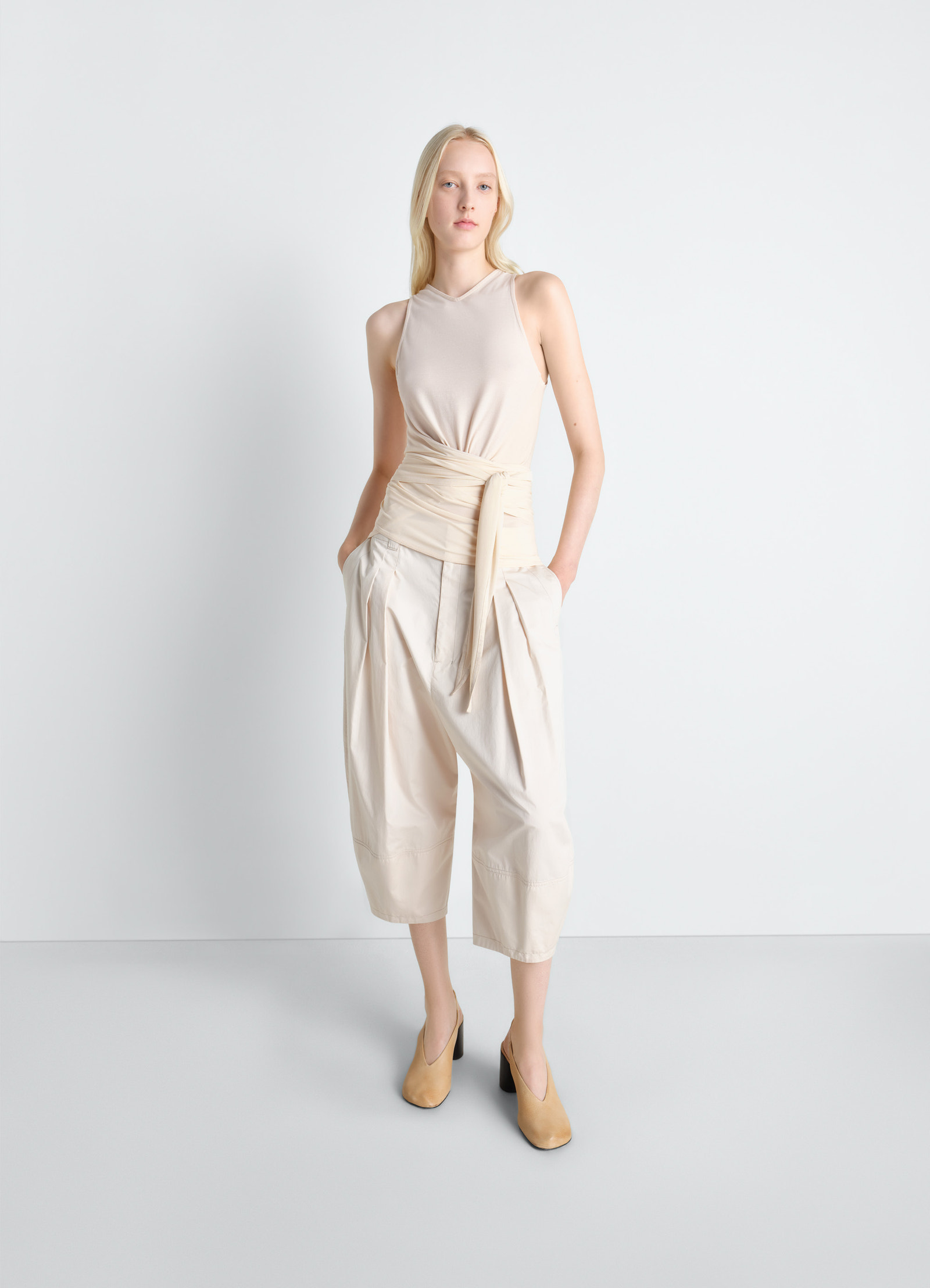 Sleeveless wrap top in viscose crepe jersey, model shot, three-quarter view tied waist