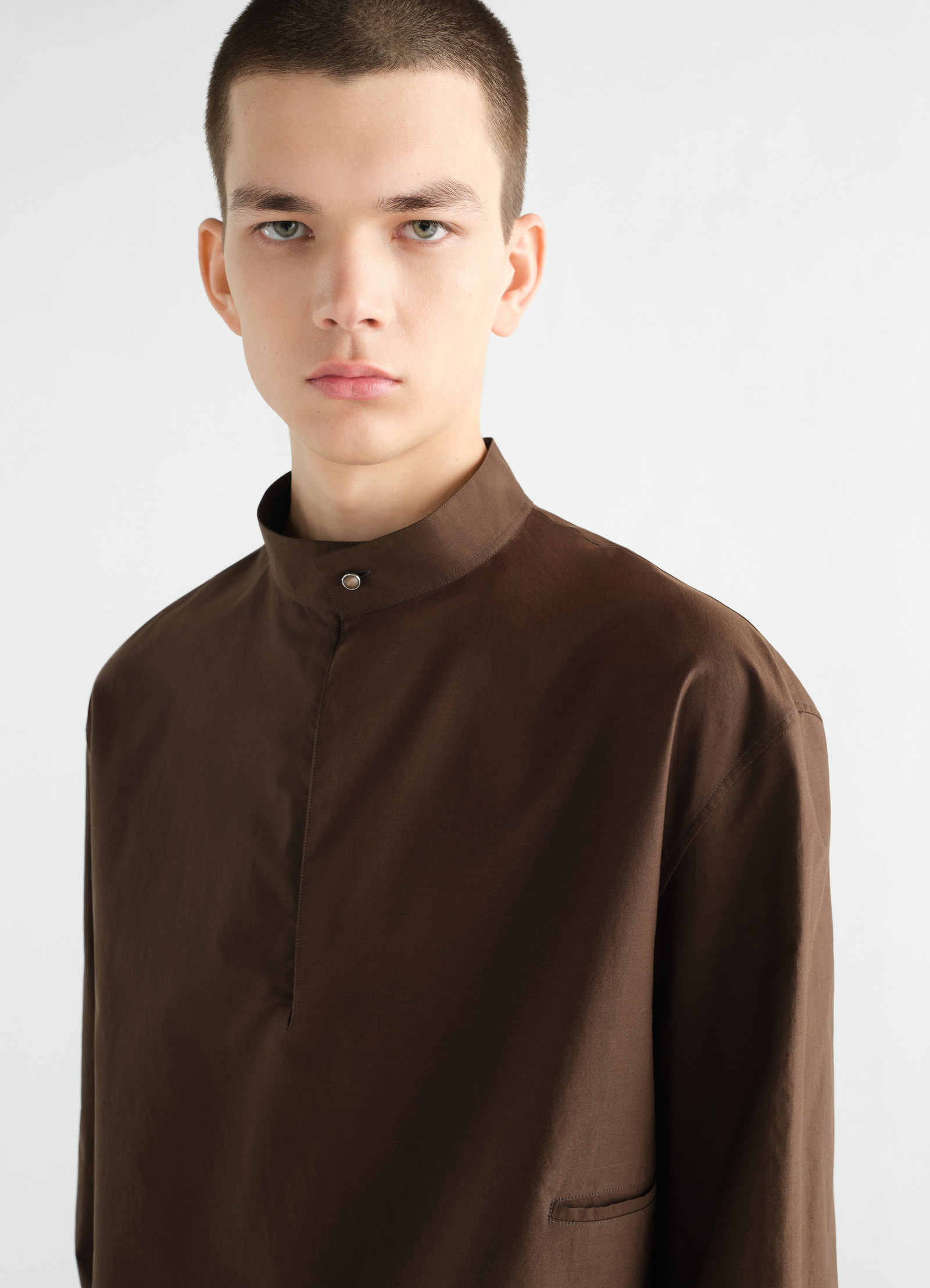 Sailor top in washed brown cotton and silk blend by lemaire worn by model with stand collar front close-up