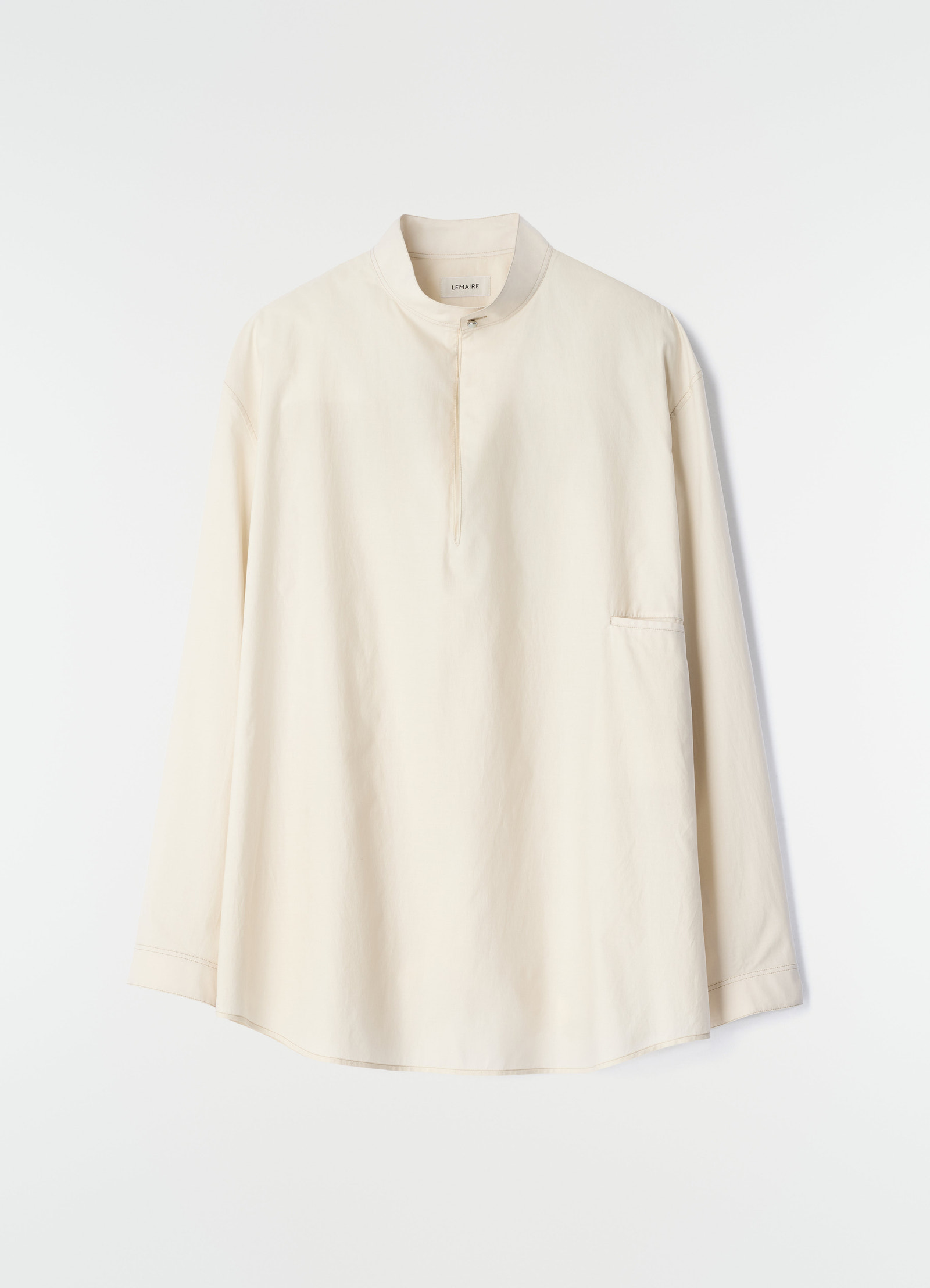 Sailor top in washed cotton and silk blend beige with high collar and front button by lemaire on white background
