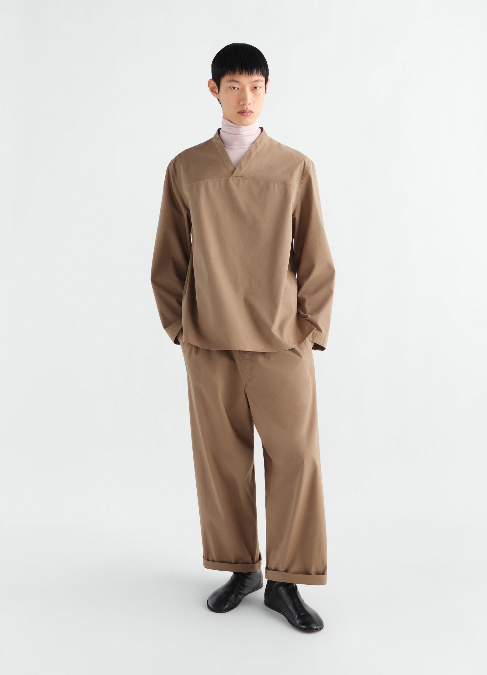 V-neck light brown cotton twill top worn by model with matching pants lemaire front view