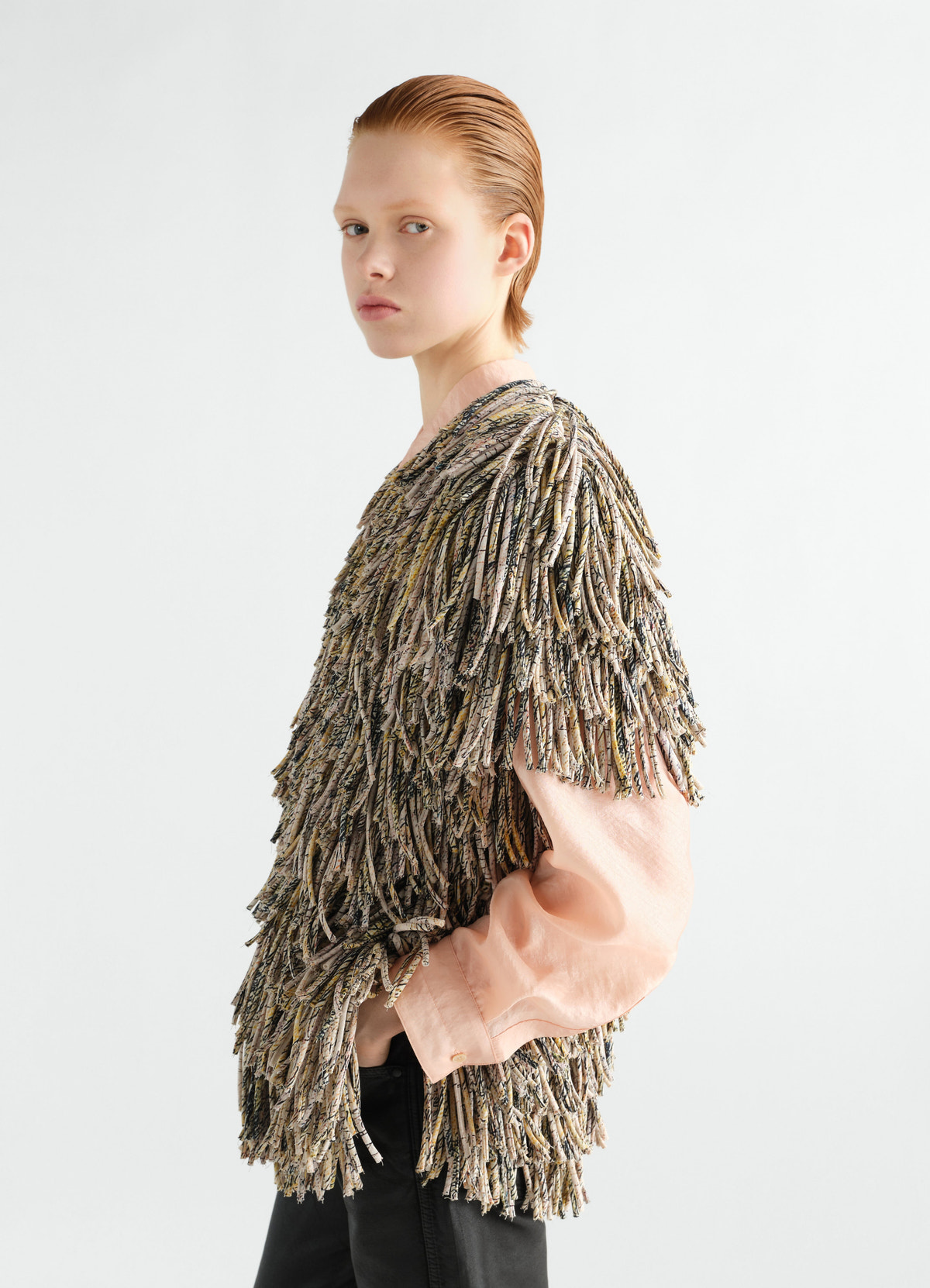 Fringed dry silk top in flashback print by lemaire worn by model side view with pink shirt sleeve and black pants