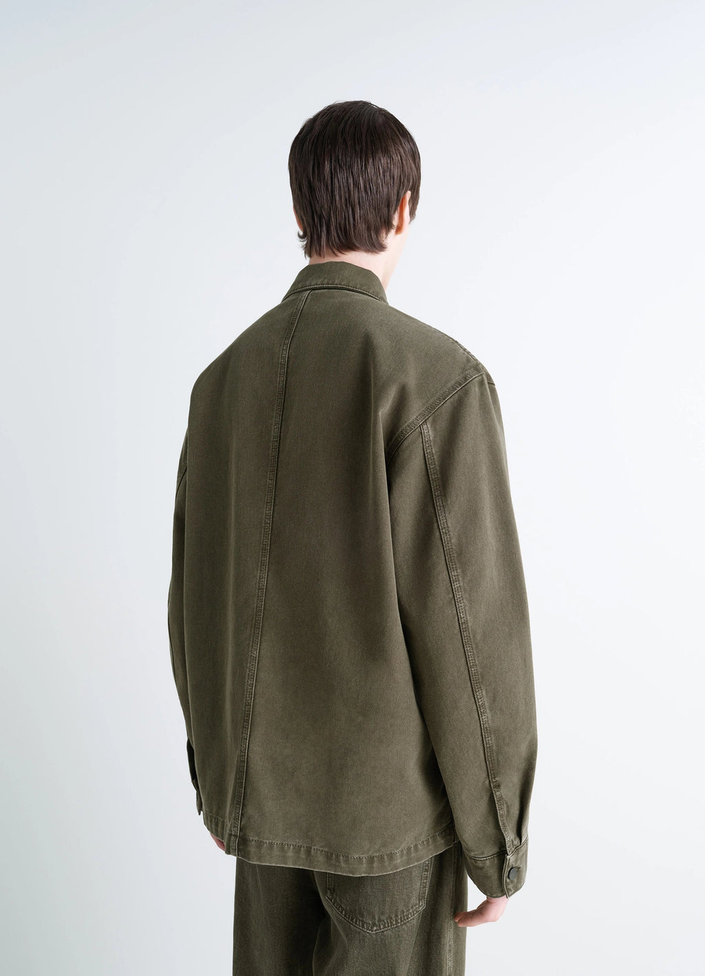 Lemaire Workwear Overshirt in Garment Dyed Snowy Denim, model shot, back view straight back seam
