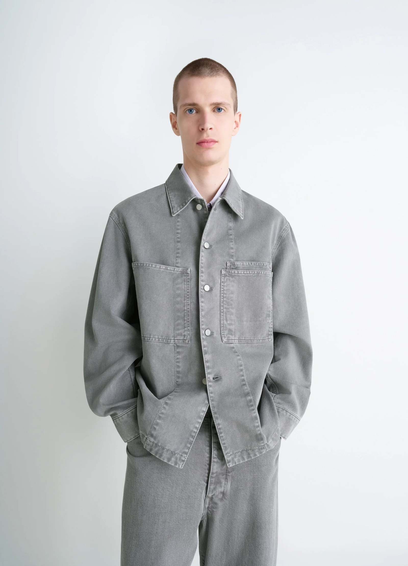 Lemaire workwear overshirt in garment dyed snow medium denim, model shot, front view loose fit, dual chest pockets