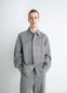 Lemaire Workwear Overshirt in Garment Dyed Snow Medium Denim, model shot, front view loose fit, dual chest pockets