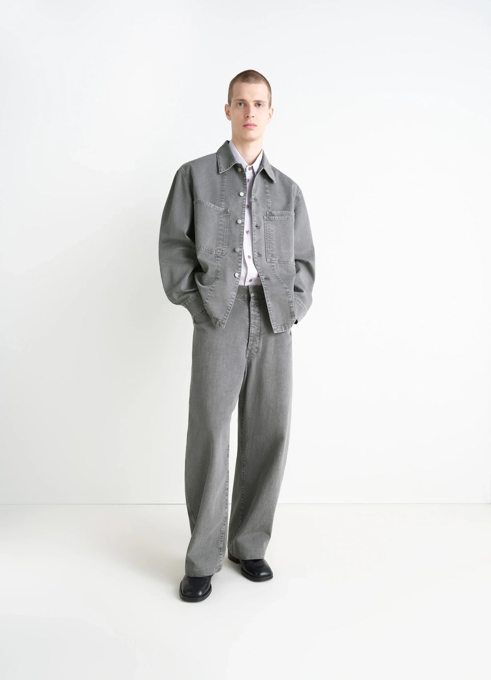 Lemaire Workwear Overshirt in Garment Dyed Snow Medium Denim, model shot, three-quarter view relaxed fit, cuffed sleeves