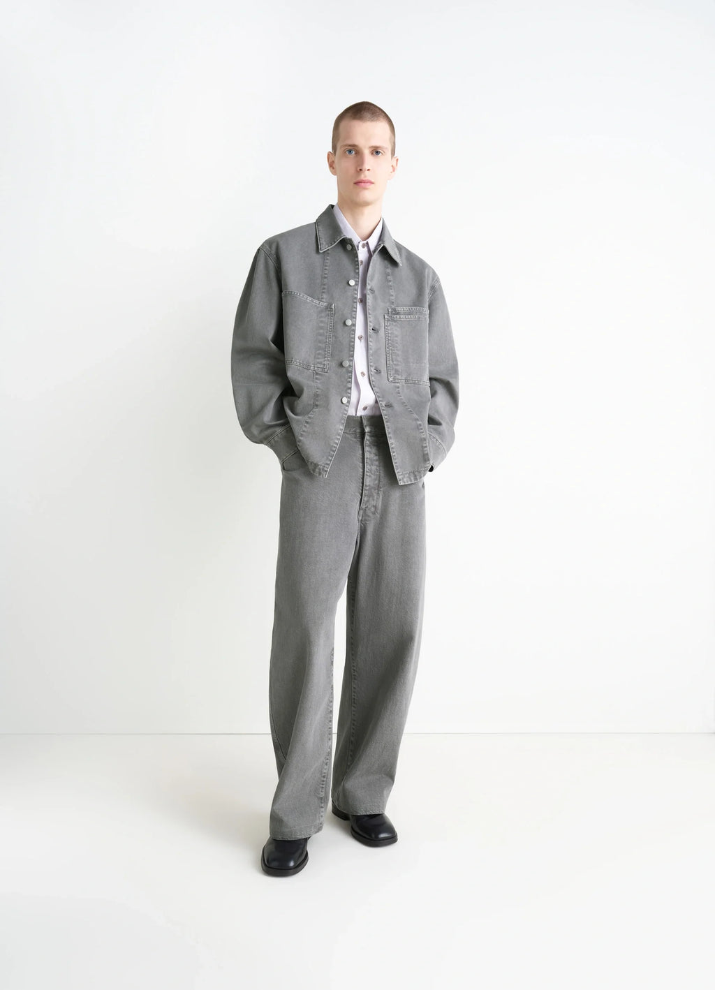 Lemaire Workwear Overshirt in Garment Dyed Snow Medium Denim, model shot, three-quarter view relaxed fit, cuffed sleeves
