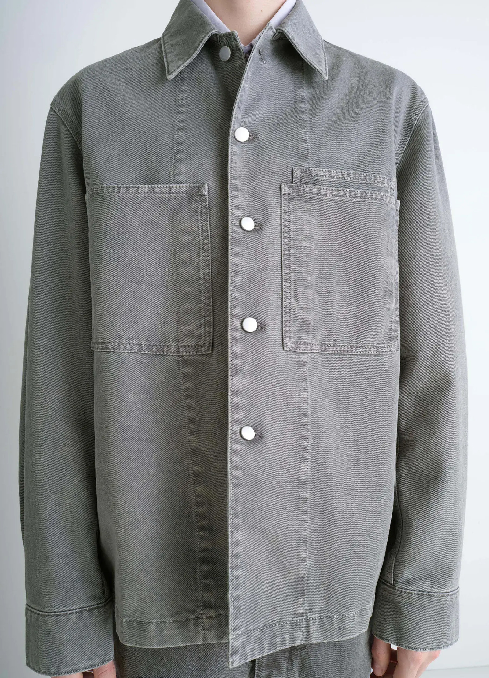Lemaire workwear overshirt in garment dyed snow medium denim, model shot, close-up front view button closure, large collar