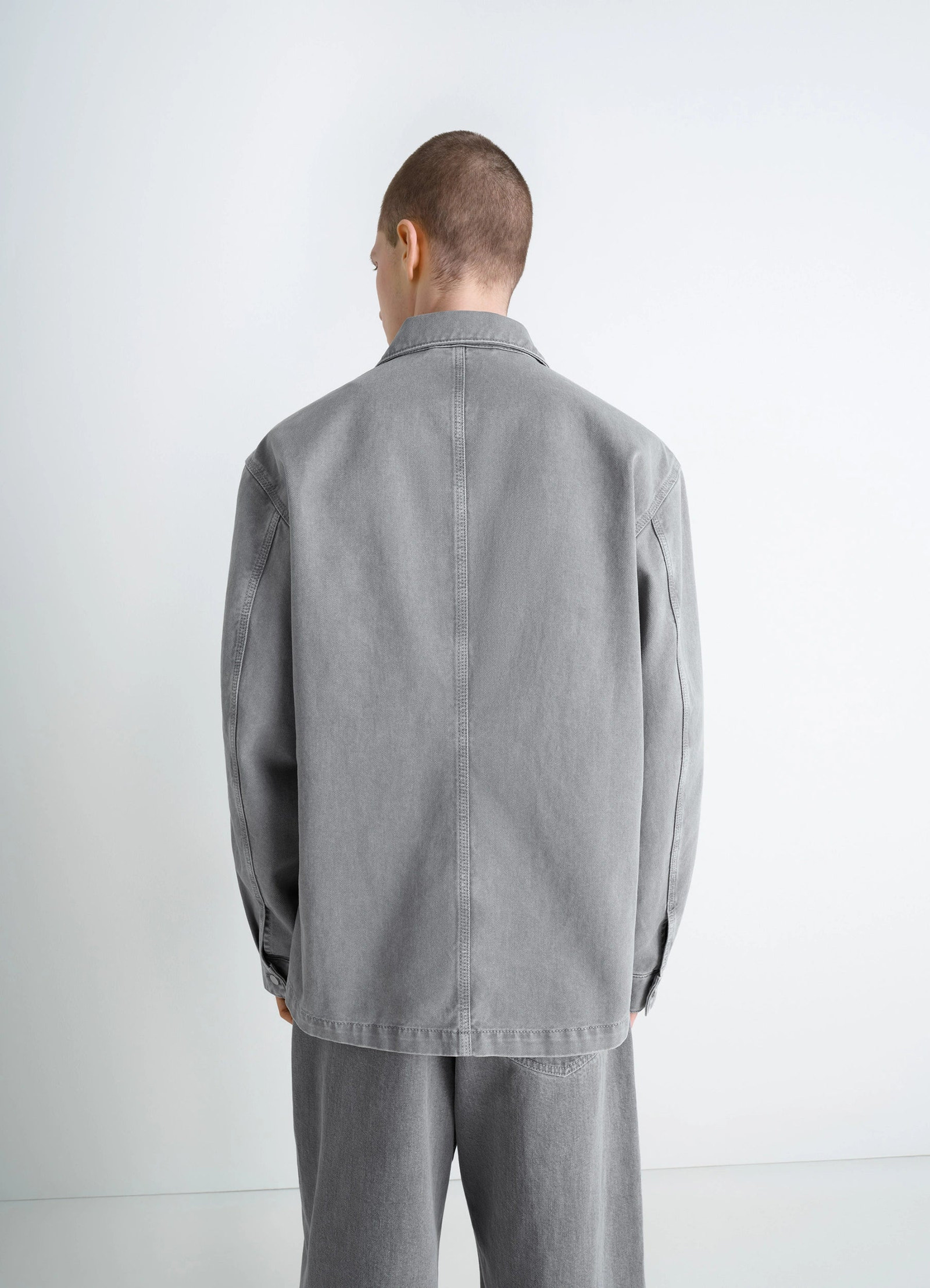 Lemaire workwear overshirt in garment dyed snow medium denim, model shot, back view straight hemline
