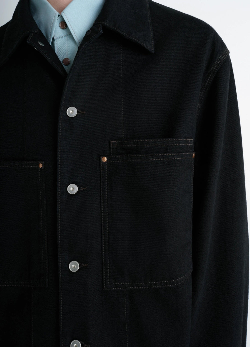 Lemaire Workwear Overshirt in Deep Black Medium-weight Denim, model shot, close-up view chest pockets, unbuttoned collar