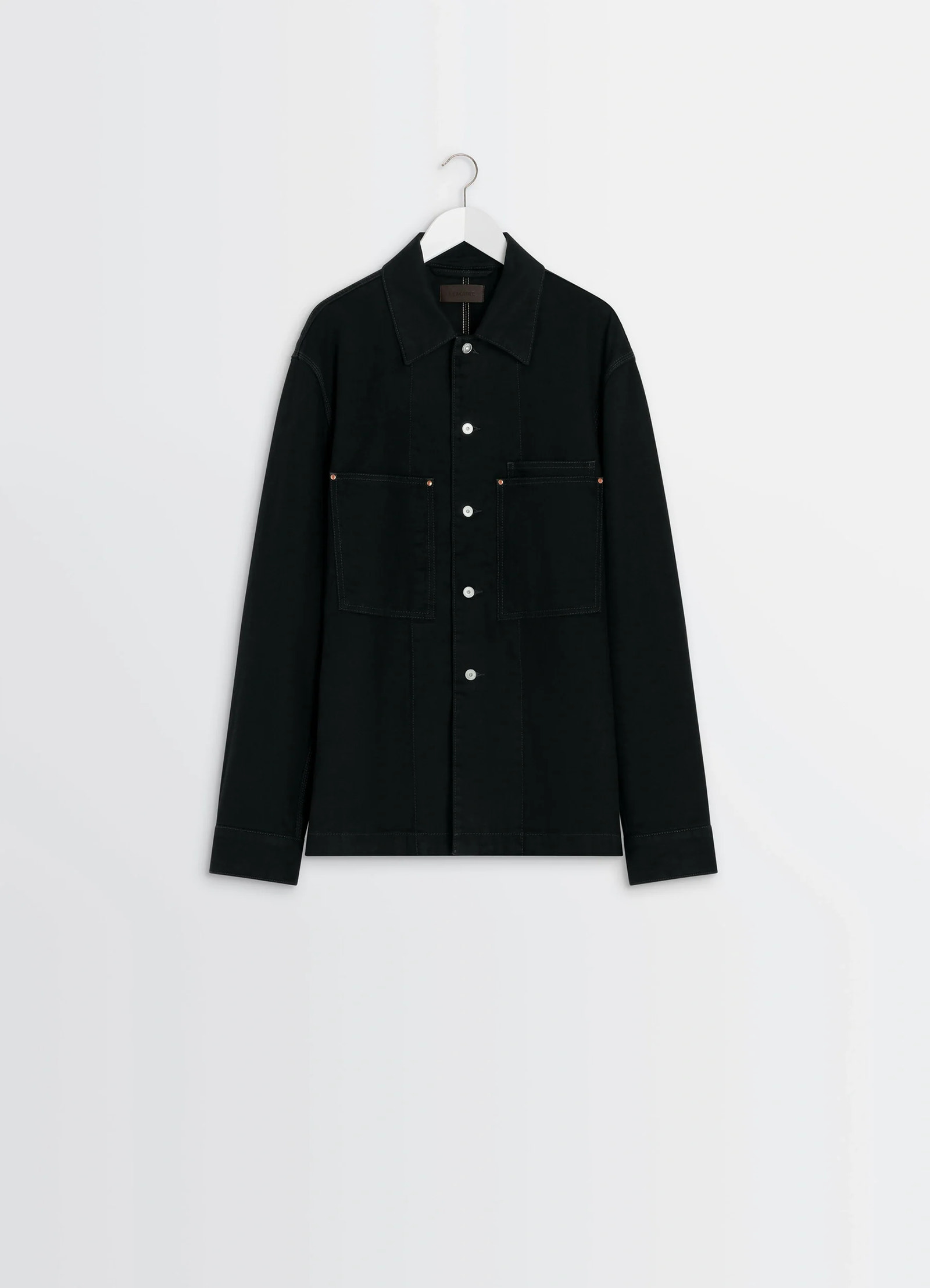 Lemaire workwear overshirt in deep black medium-weight denim, product shot, side view hanging long sleeves visible