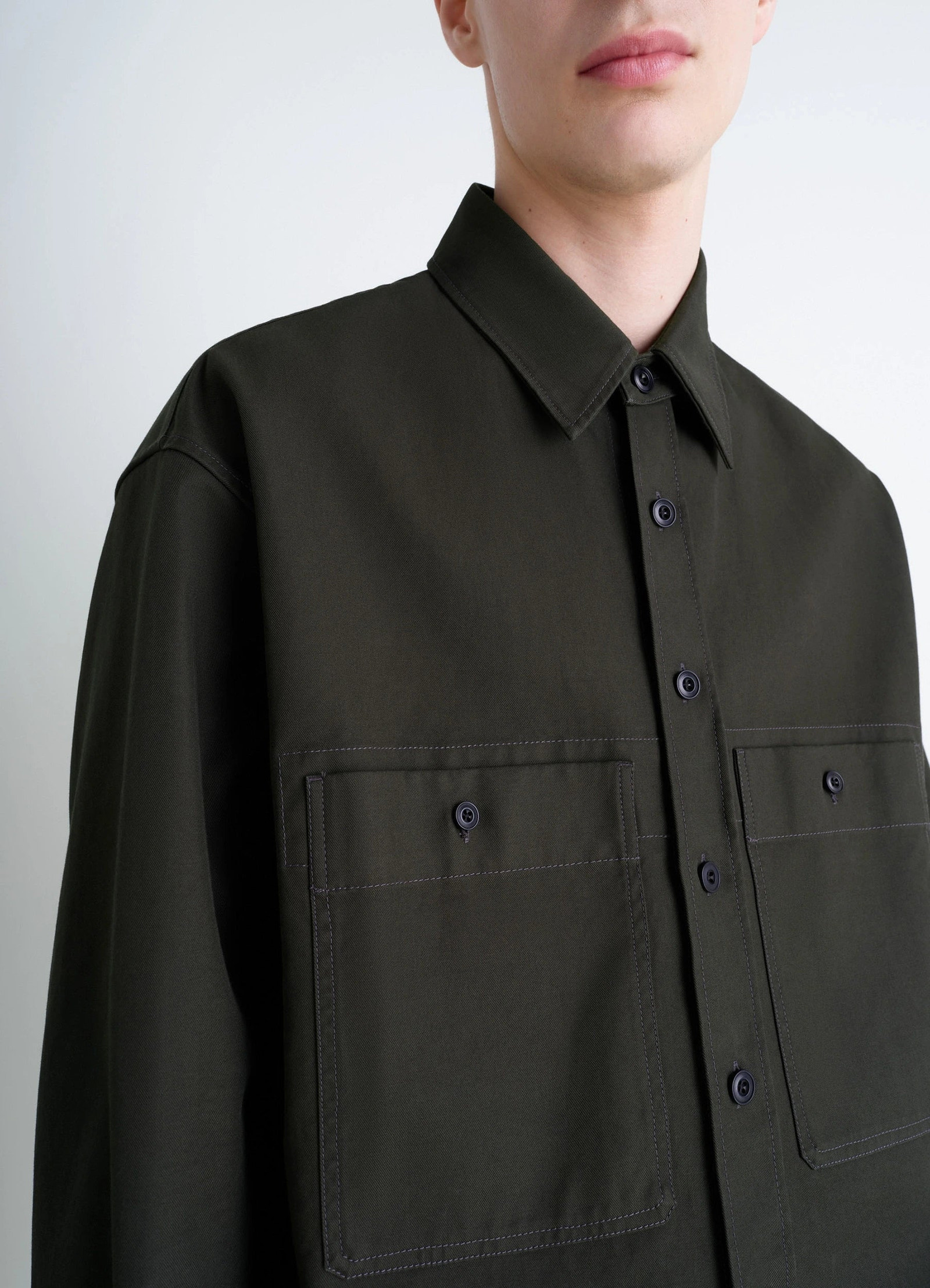 Utility overshirt in thick cotton twill, model shot, close-up side view large buttoned pockets