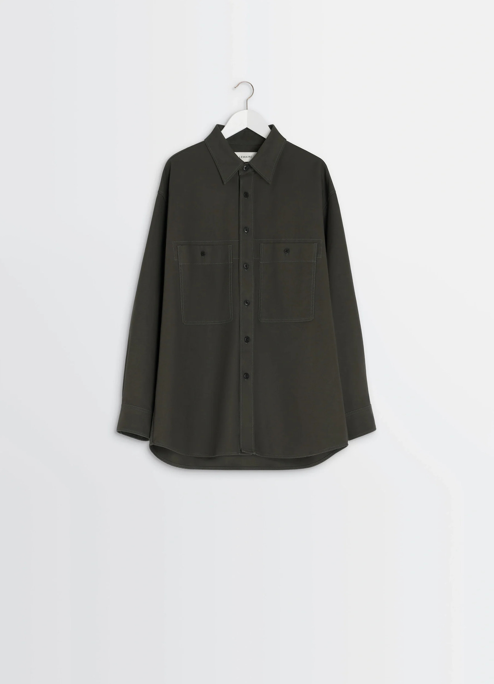 Utility overshirt in thick cotton twill, product shot, hanging view curved hem