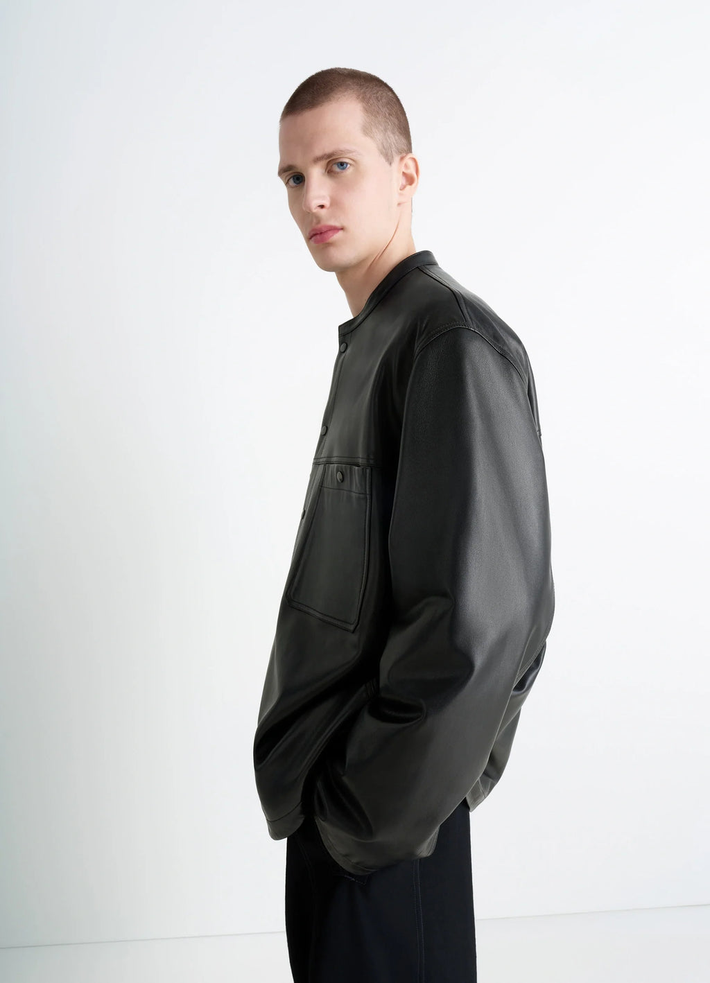 Leather Collarstand Overshirt in Nappa Lamb Leather, model shot, profile side view minimalist shoulder seam