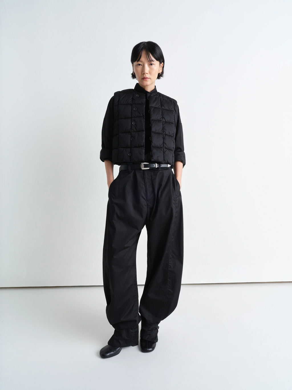 Lemaire Wadded Gilet in Black Cotton Satin, model shot, front side view cropped length, button front