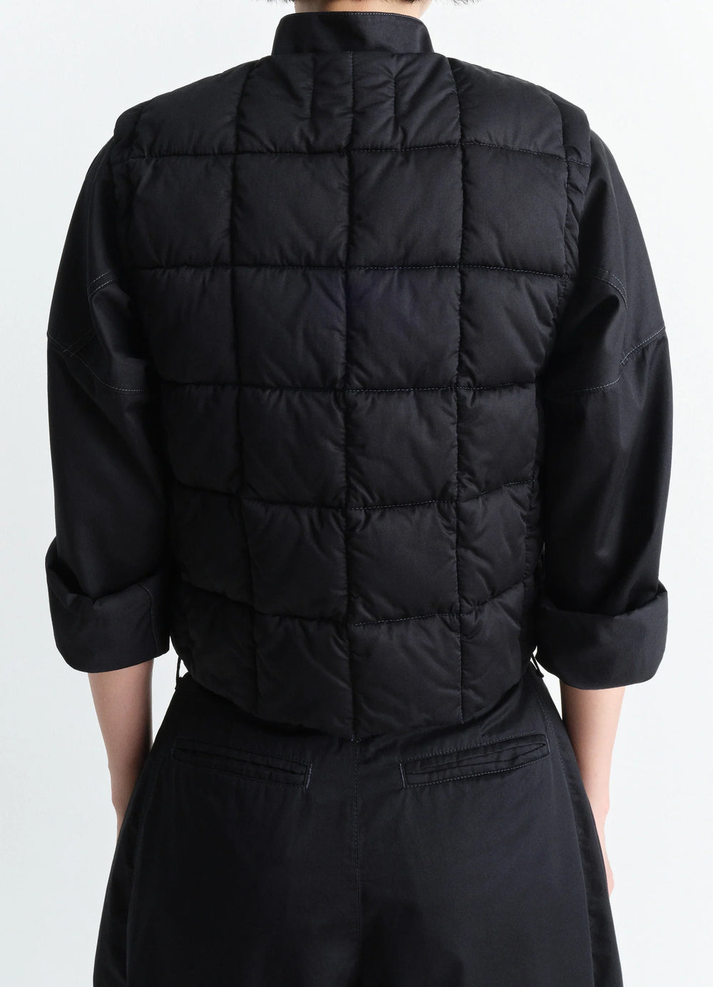 Lemaire Wadded Gilet in Black Cotton Satin, model shot, back view quilted texture