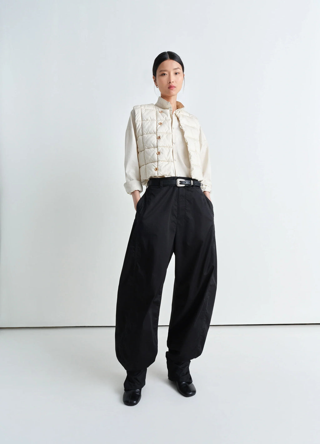 Lemaire Wadded Gilet in Light Cotton Satin, model shot, three-quarter view boxy fit, styled unbuttoned