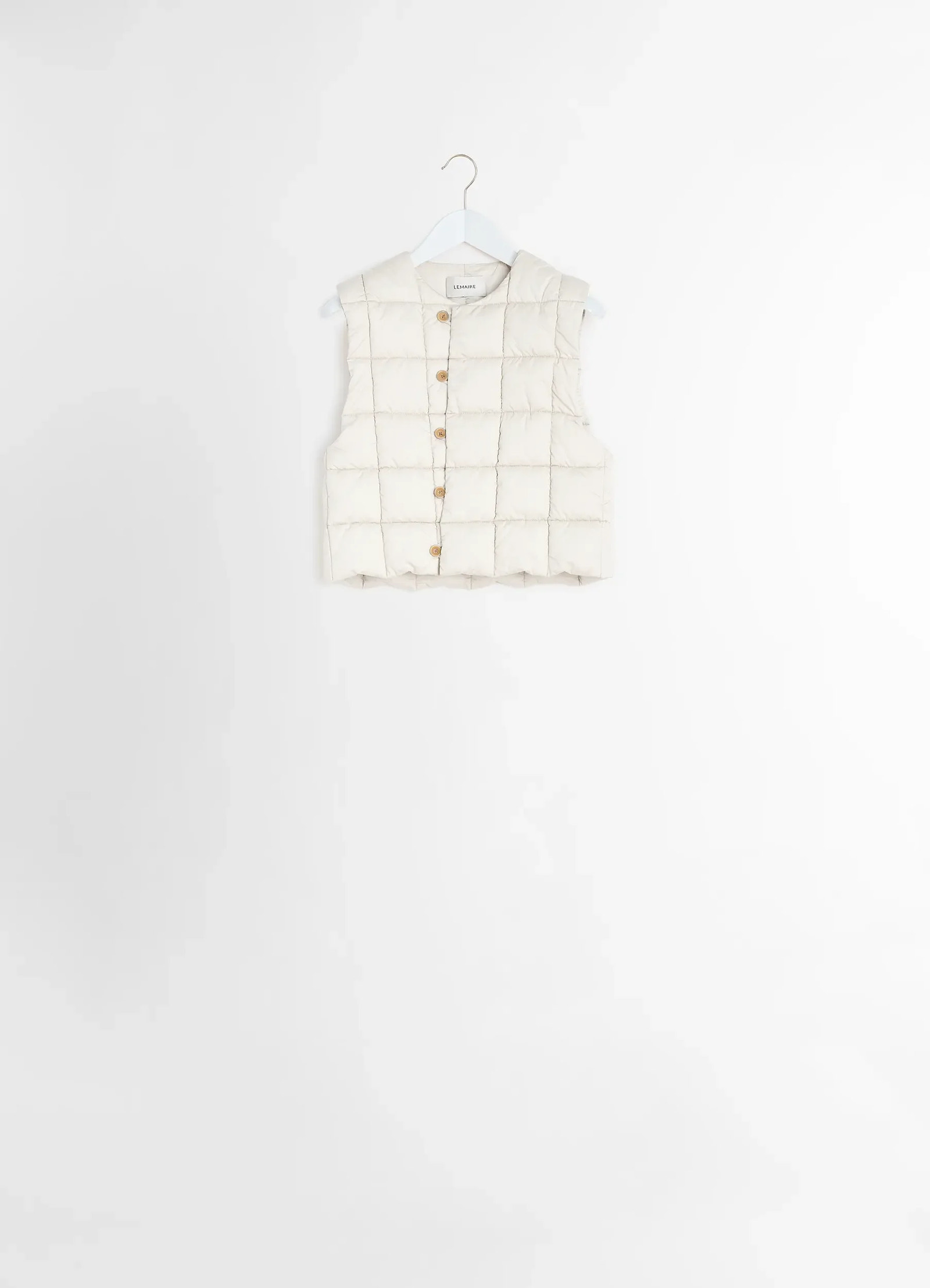 Lemaire wadded gilet in light cotton satin, product shot, back view quilted pattern, hung on hanger