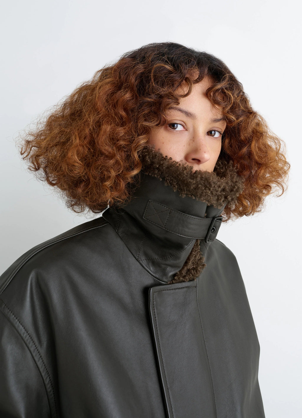 Lemaire Leather Blouson in Nappa Cow Leather Shearling, model shot, close-up portrait high collar, buckle closure