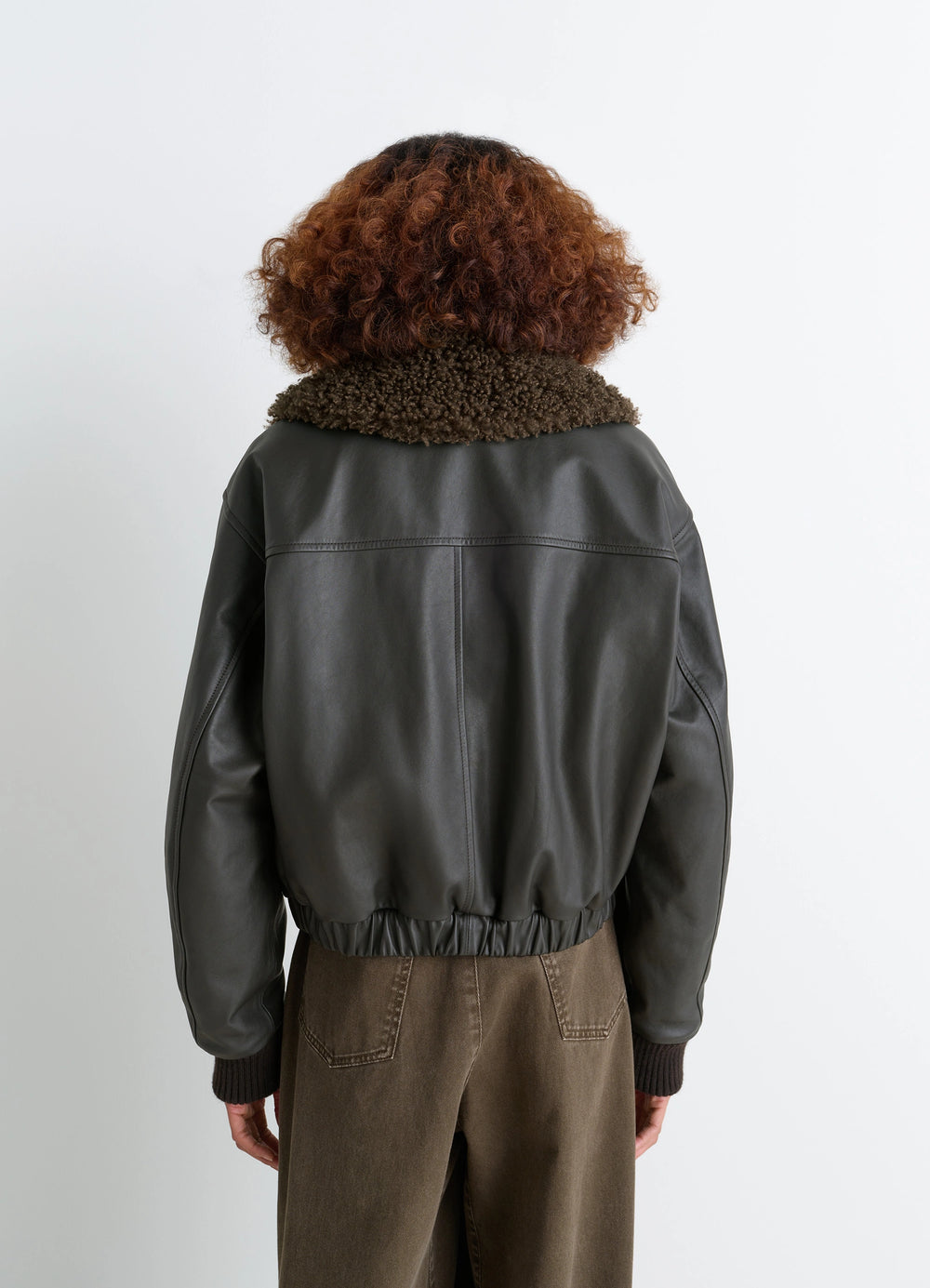 Lemaire Leather Blouson in Nappa Cow Leather Shearling, model shot, back view fur collar, elastic hem