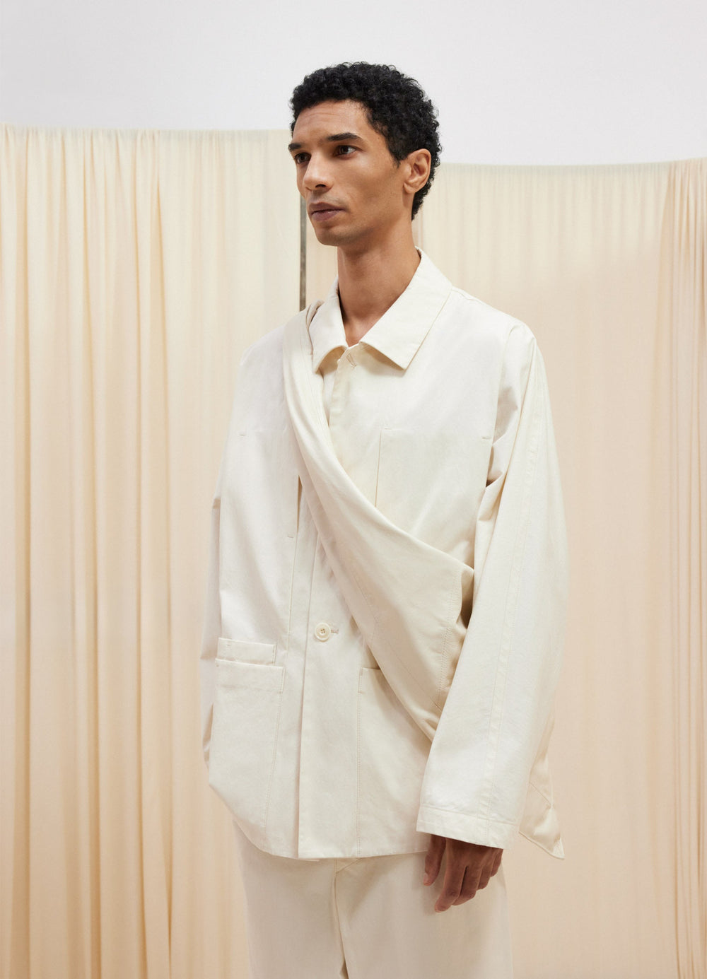 Lemaire Boxy Single Breasted Jacket in Off-White Cotton Bachette, model shot, Three-quarter front vie Boxy fit, flared sleeve
