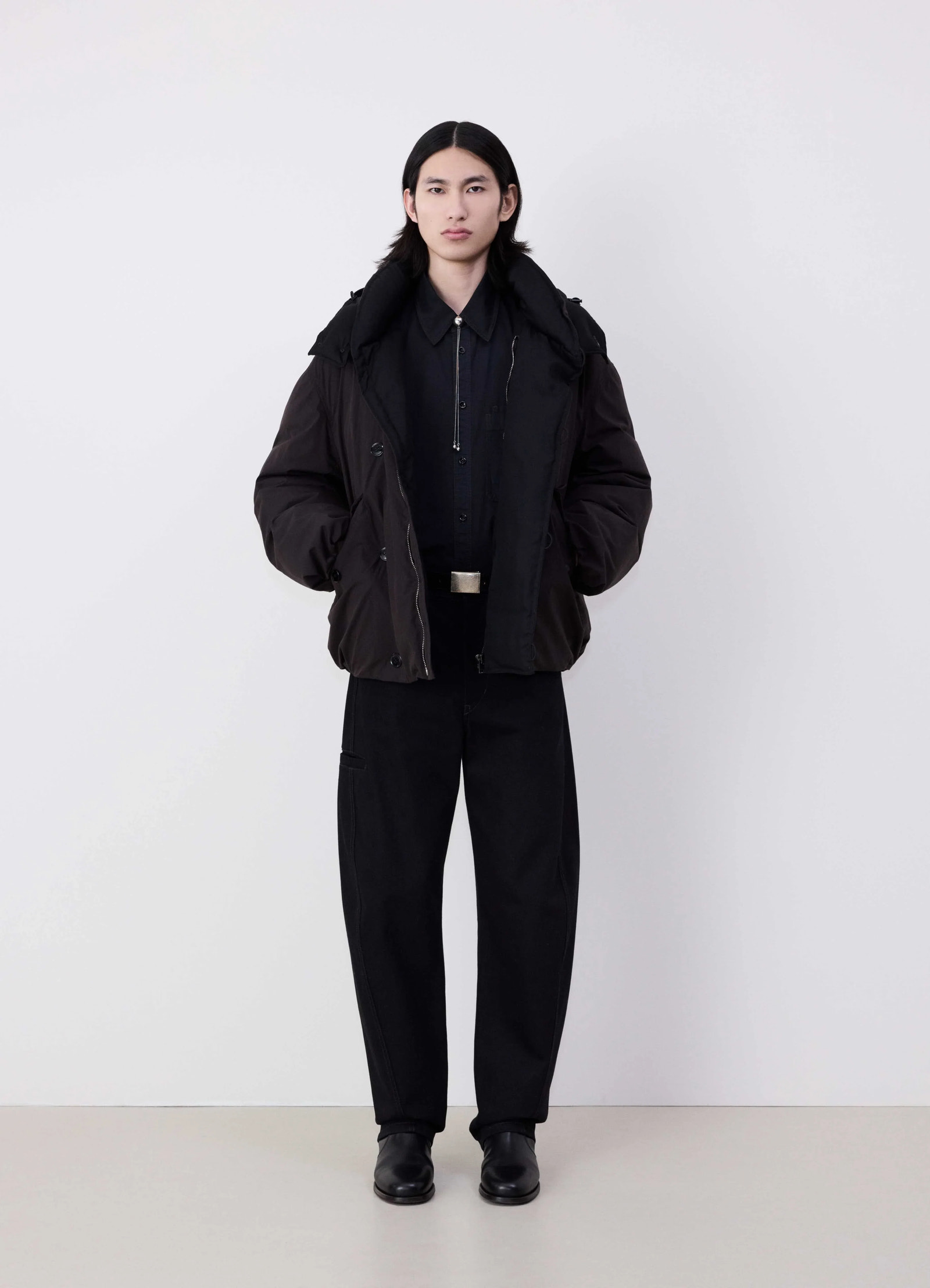 Lemaire hooded puffer blouson in dark cotton blend, model shot, full body front view felted collar detail