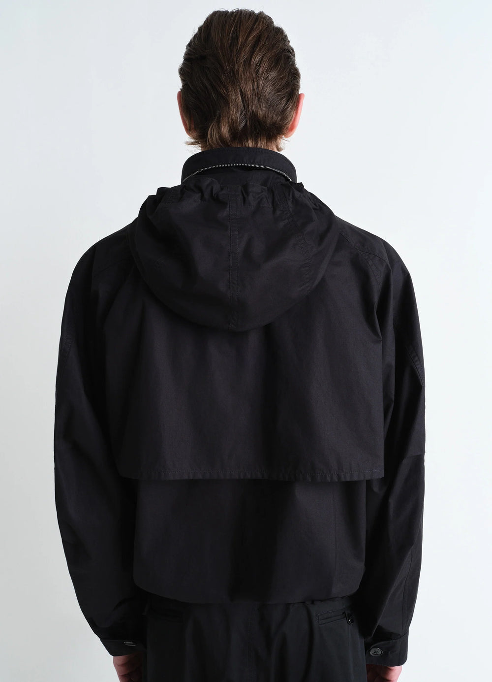 Parachute Blouson in Black VENTILE® Cotton, model shot, back view hooded rear vent