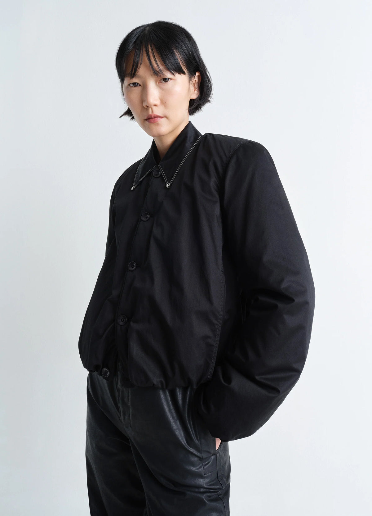 LEMAIRE Wadded Blouson in Black Cotton Satin, model shot, Front view Round shape, corozo buttons