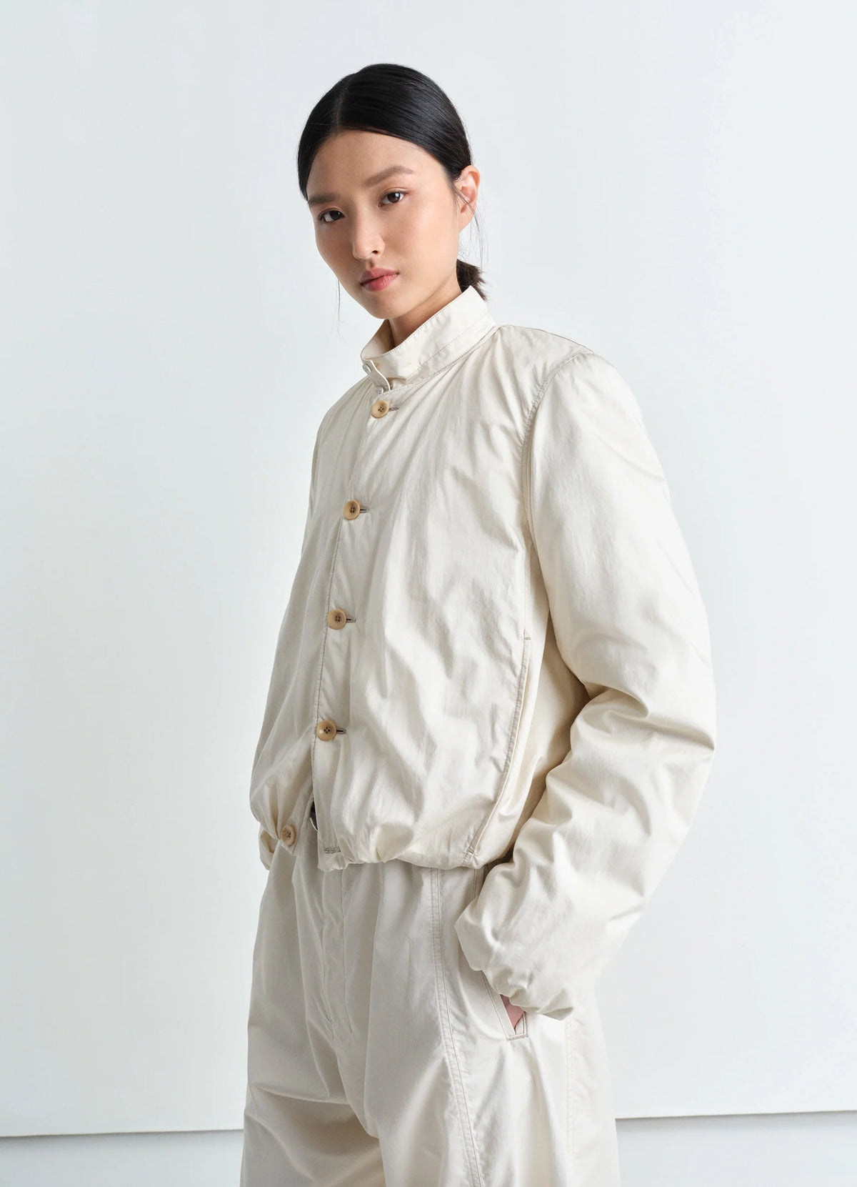 Lemaire Wadded Blouson in Light Cotton Satin, model shot, Front side view Round collar, corozo buttons