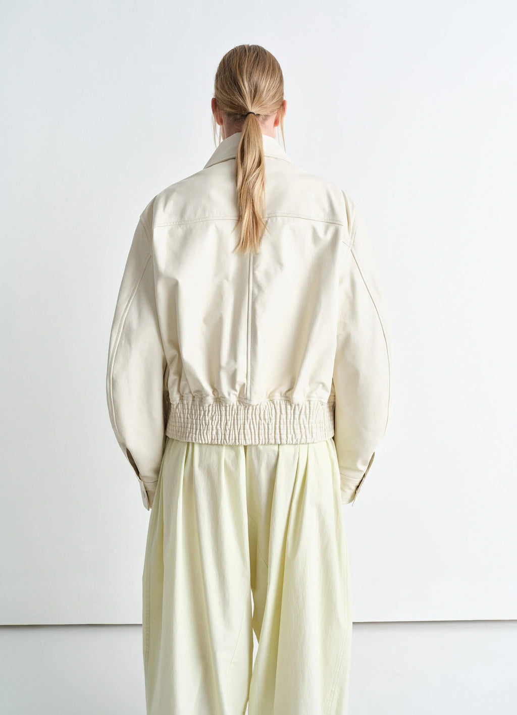 Lemaire Leather Blouson in Soft Nappa Cow Leather, model shot, back view cropped length, gathered hem