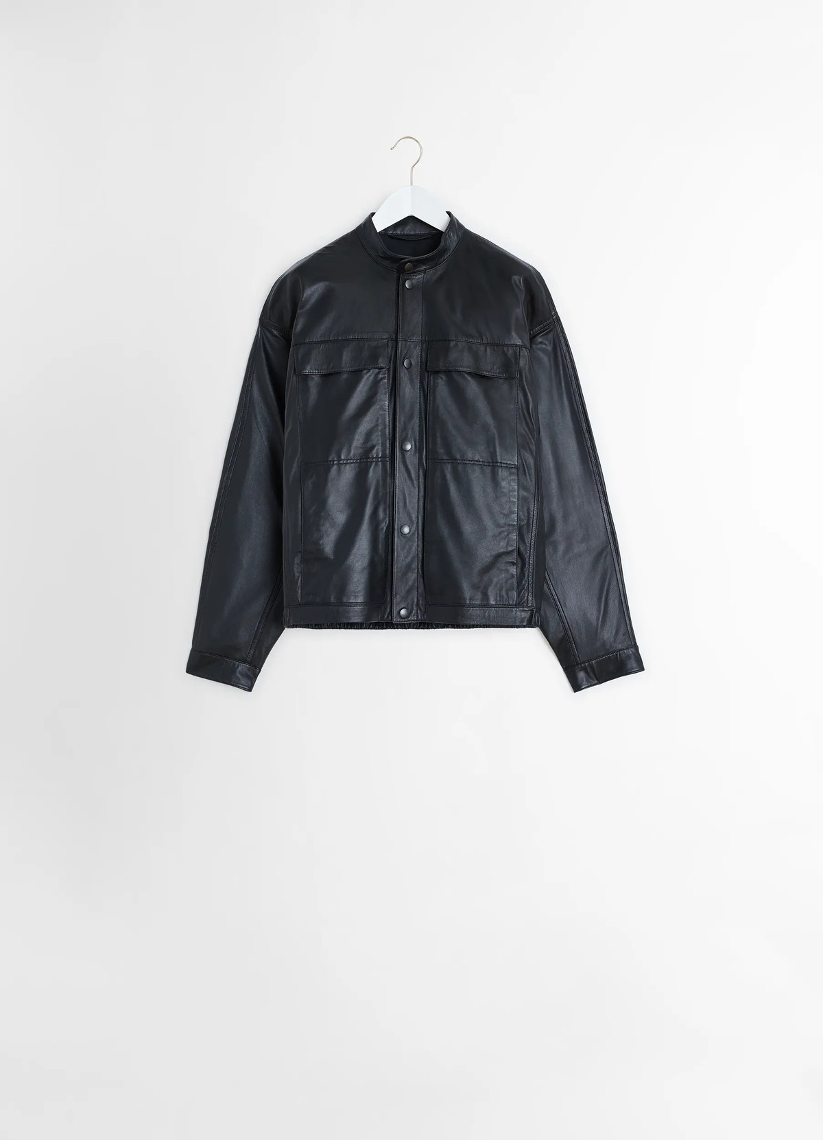 Soft boxy blouson in black lamb leather, product shot, hanger hanging view snap button centered