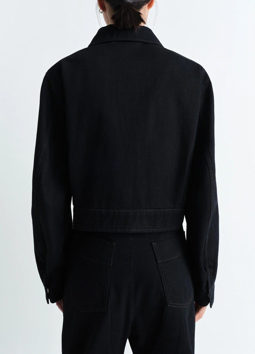 Lemaire Two Pocket Cropped Jacket in Deep Black Heavy Denim, model shot, back view buttoned cuffs straight back