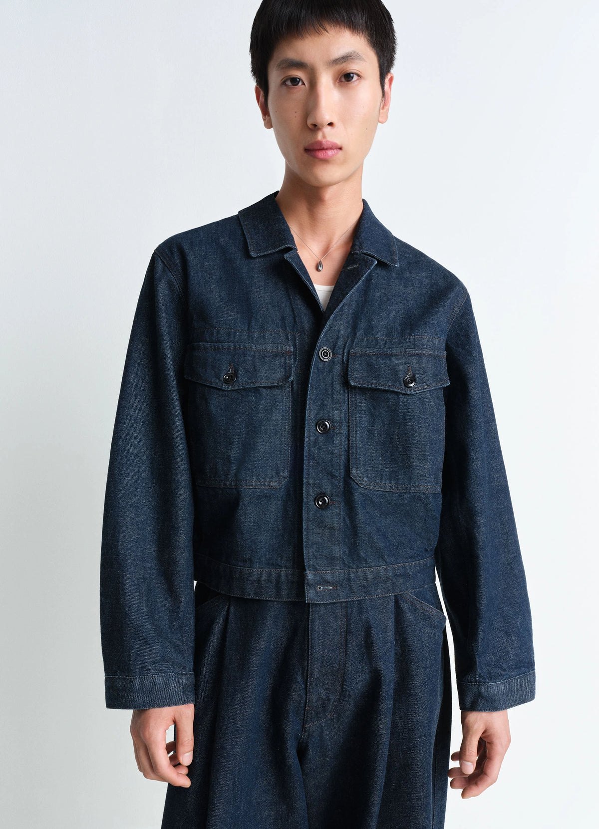 Lemaire Trucker Jacket in Deep Indigo Heavy Denim, model shot, Front view Boxy shape workwear collar