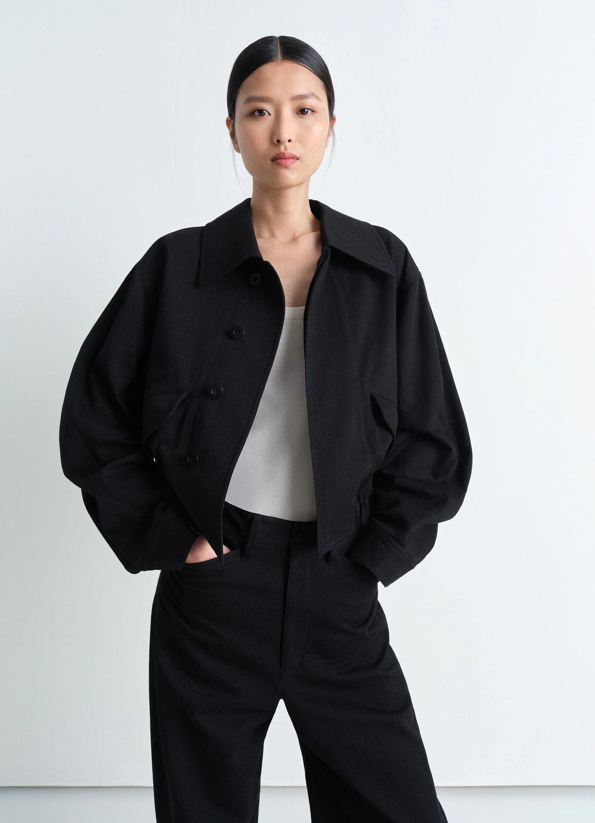 Lemaire Short Blouson in Black Heavy Cotton Drill, model shot, Front view Rounded fit with elasticated hem