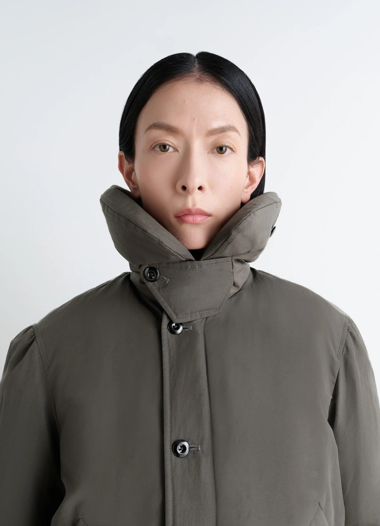 Lemaire short puffer blouson in linen cotton blend, model shot, close-up detail shot high collar button details