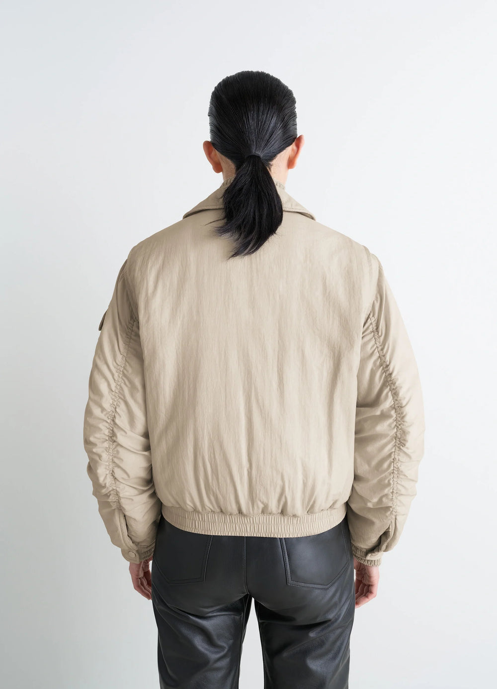 Lemaire Short Bomber in Beige Lightweight Nylon, model shot, back view elastic hem