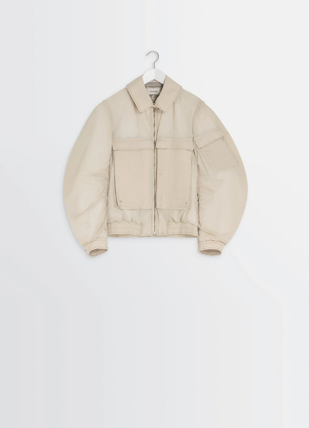 Lemaire Short Bomber in Beige Lightweight Nylon, product shot, hanger front view structured shoulders, visible zip