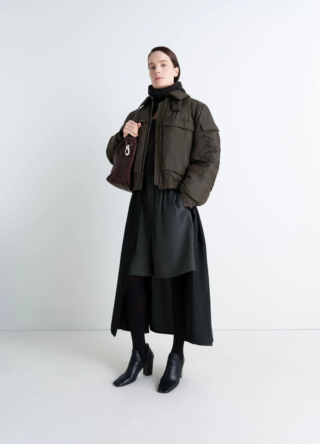 Lemaire Short Bomber in Olive Water-Repellent Nylon, model shot, three-quarter view cropped length puff sleeves