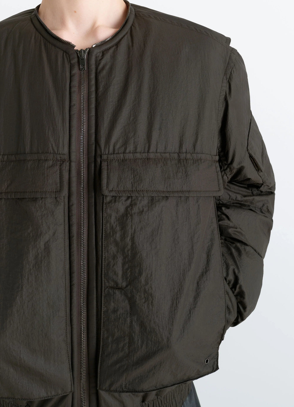 Lemaire Short Bomber in Olive Water-Repellent Nylon, model shot, close-up front view elasticated cuffs, smooth texture