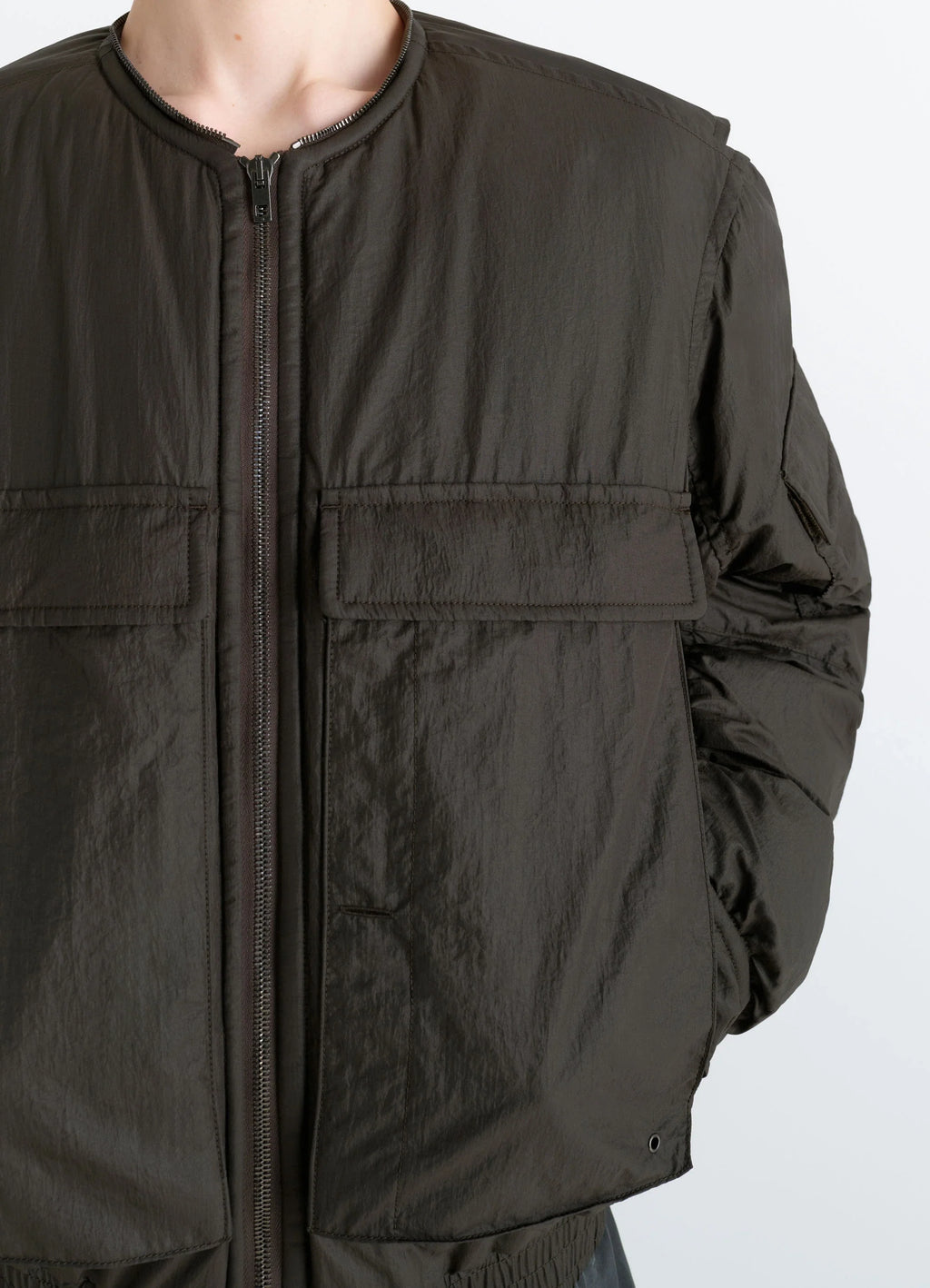 Lemaire Short Bomber in Olive Water-Repellent Nylon, model shot, close-up front view elasticated cuffs, smooth texture