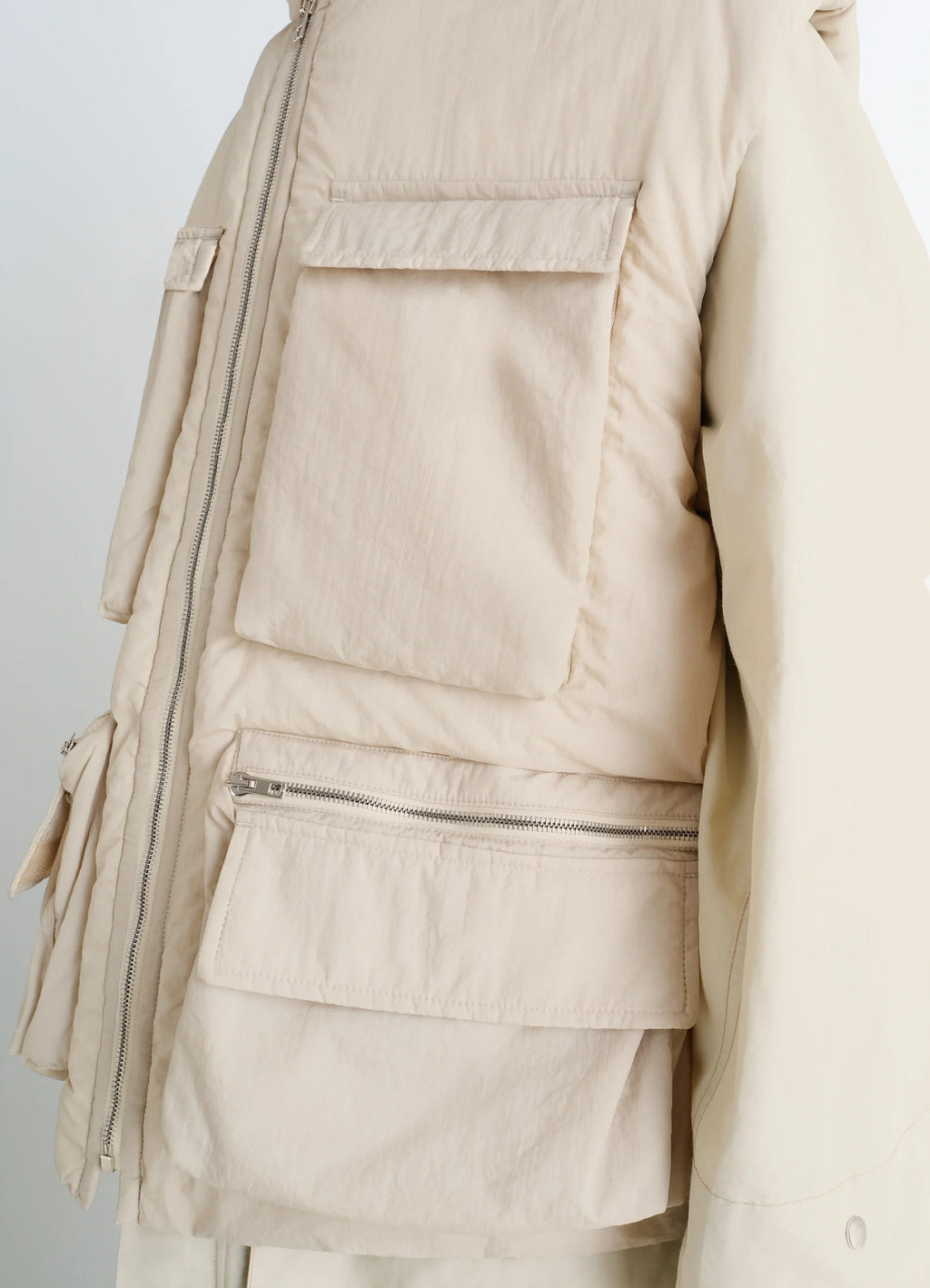 Lemaire Wadded Gilet with Pockets in Beige Water-Repellent Nylon, product shot, side detail shot zip pocket close-up